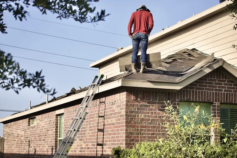 Professional roofer working on a residential roof in Cypress Meadow